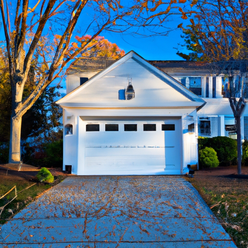 Colonial-style Medfield home with closed garage door in autumn light, driveway and trim visible.